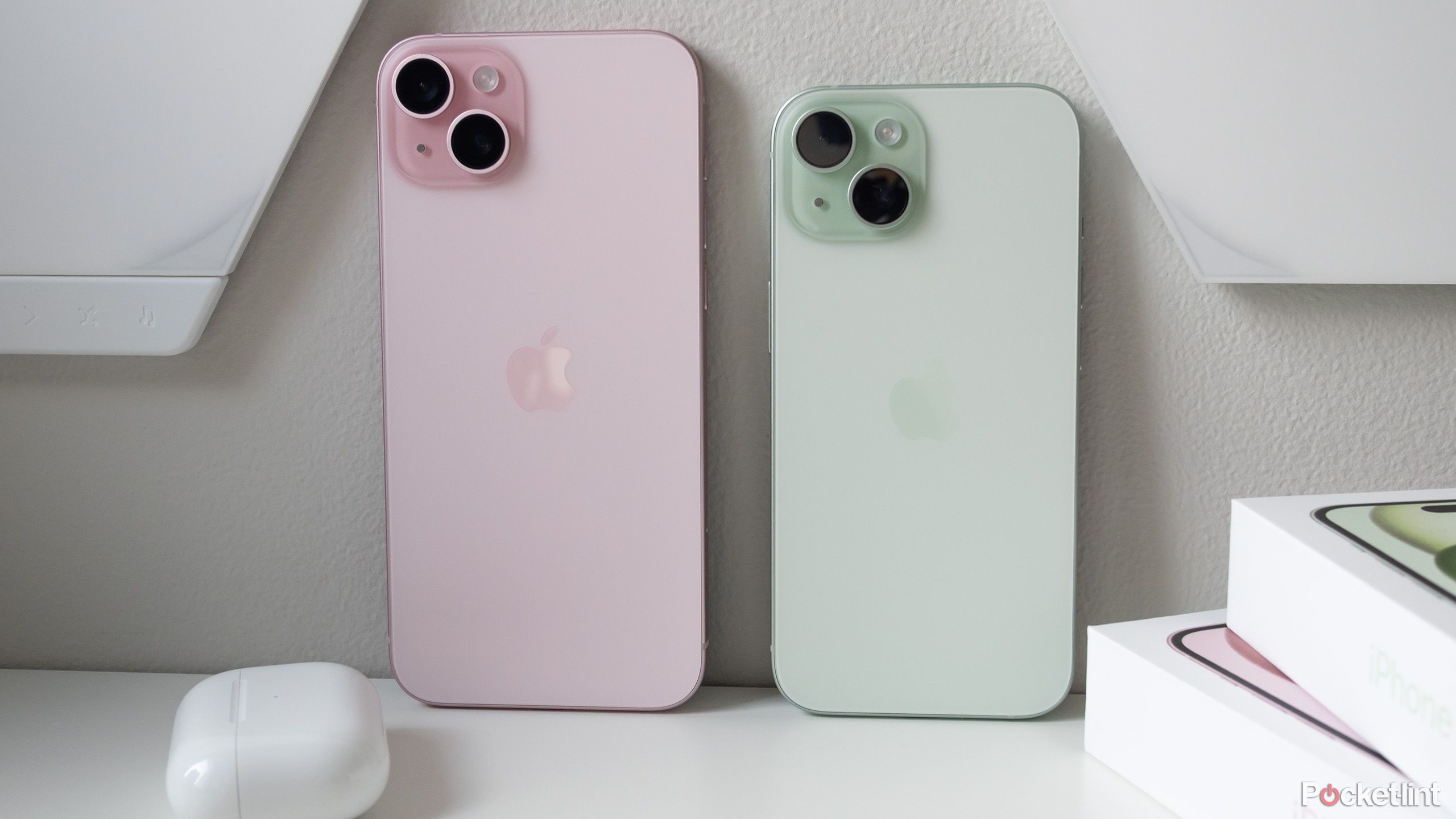 The iPhone 15 and iPhone 15 Plus against a wall 