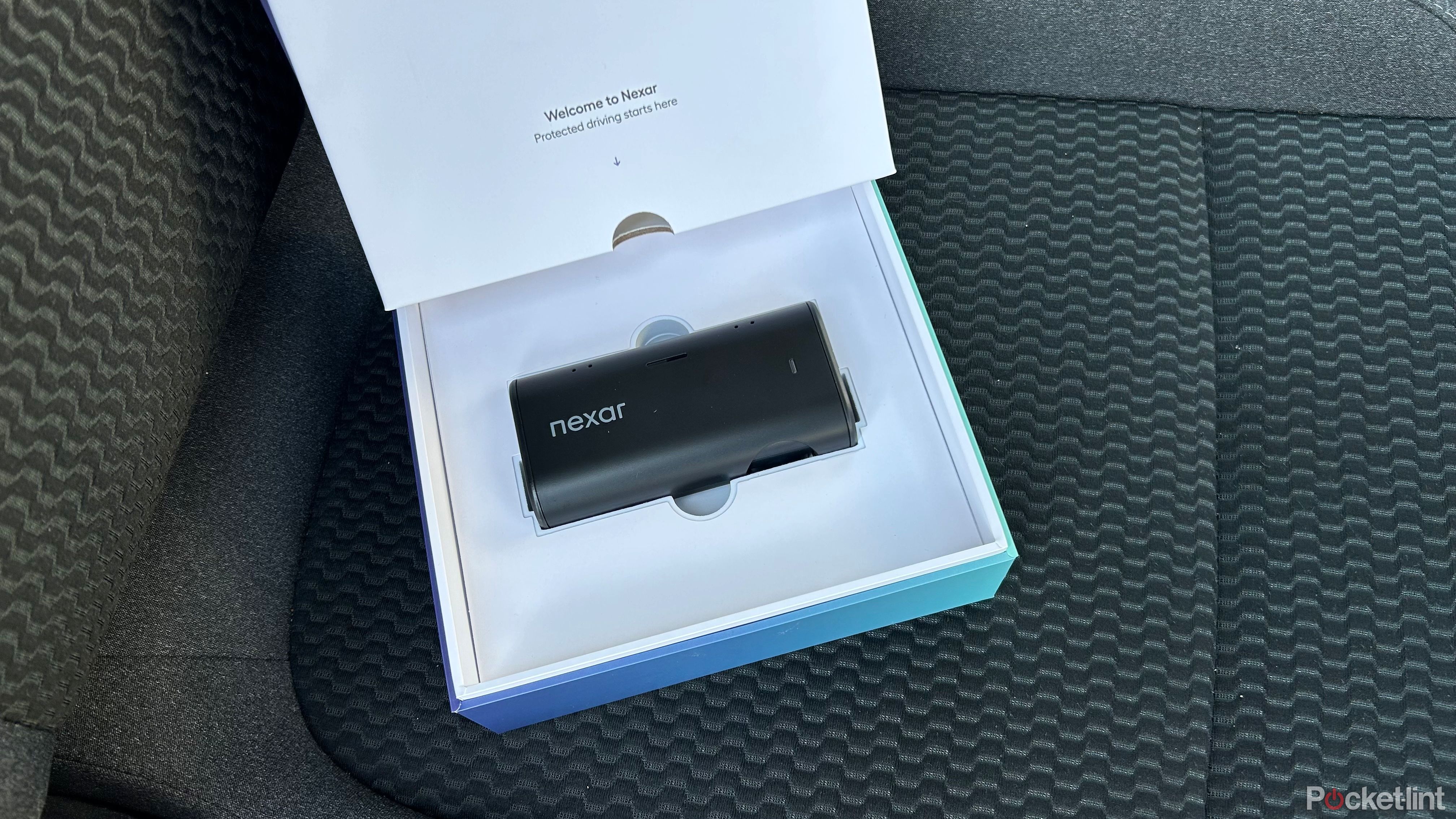 Nexar Beam2 Mini Dash Cam in the box on the seat. 