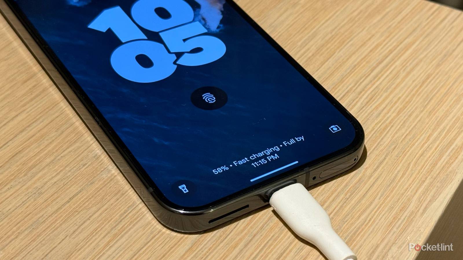 A Pixel 9 Pro charging on a desk.