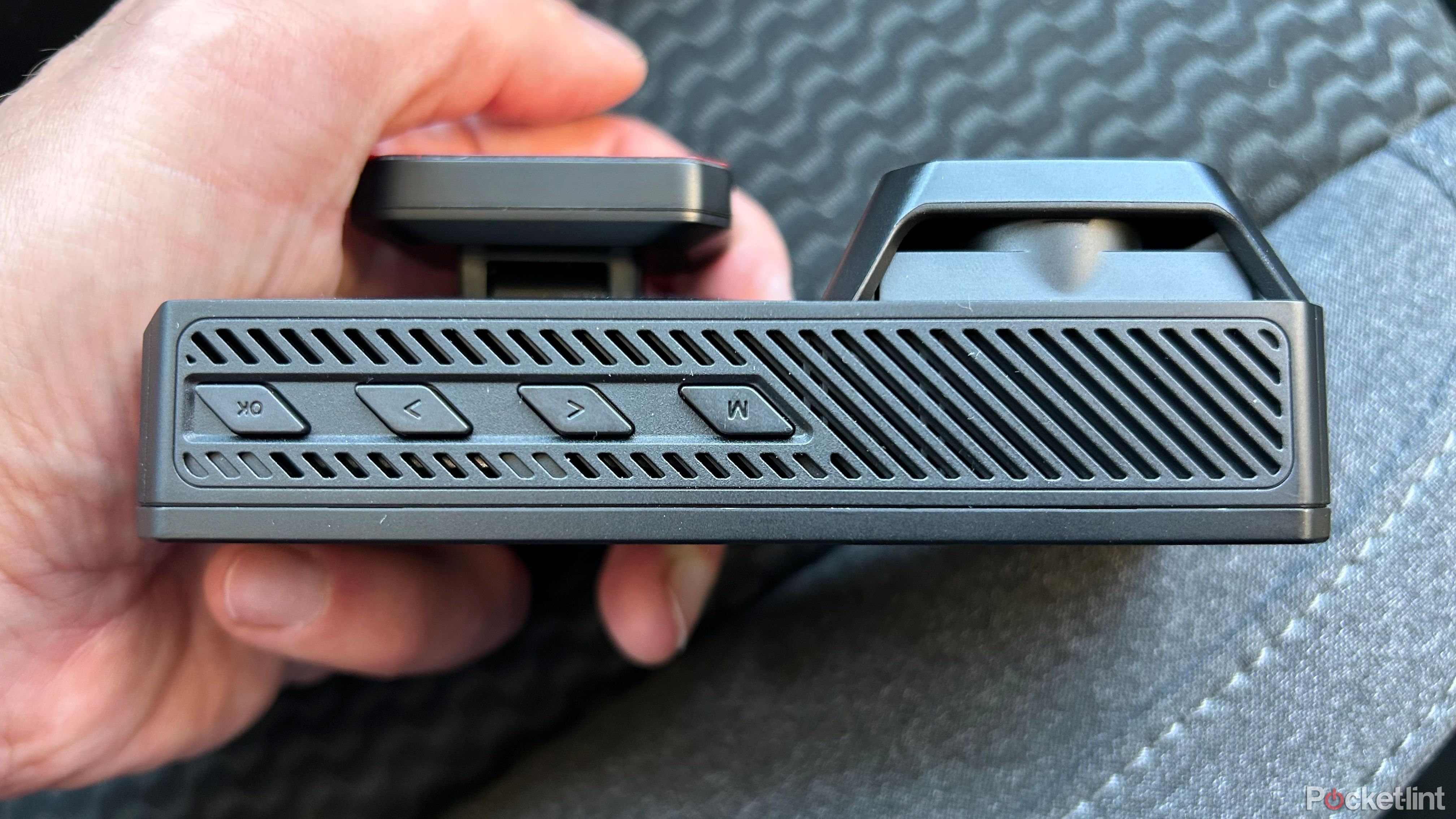 Redtiger F77 Dash Cam in hand facing the side. 