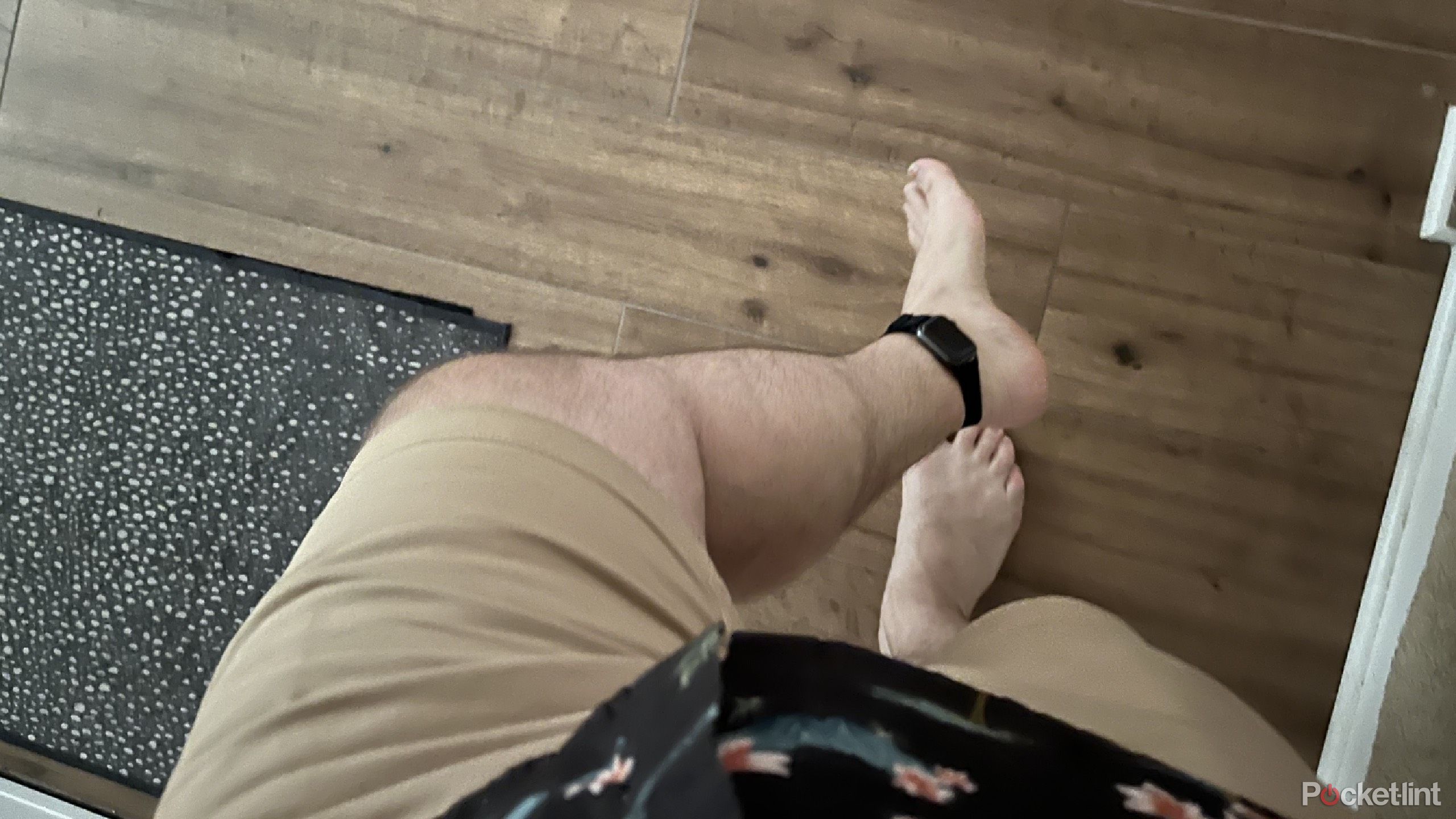 An Apple Watch around an ankle bare feet