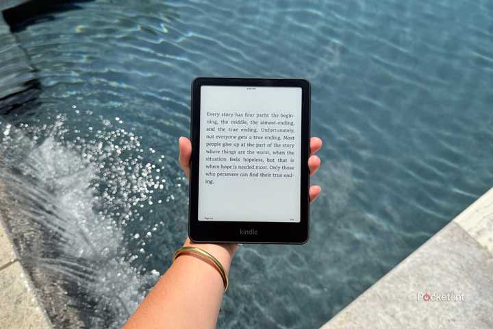 Holding a Kindle Paperwhite over the pool.