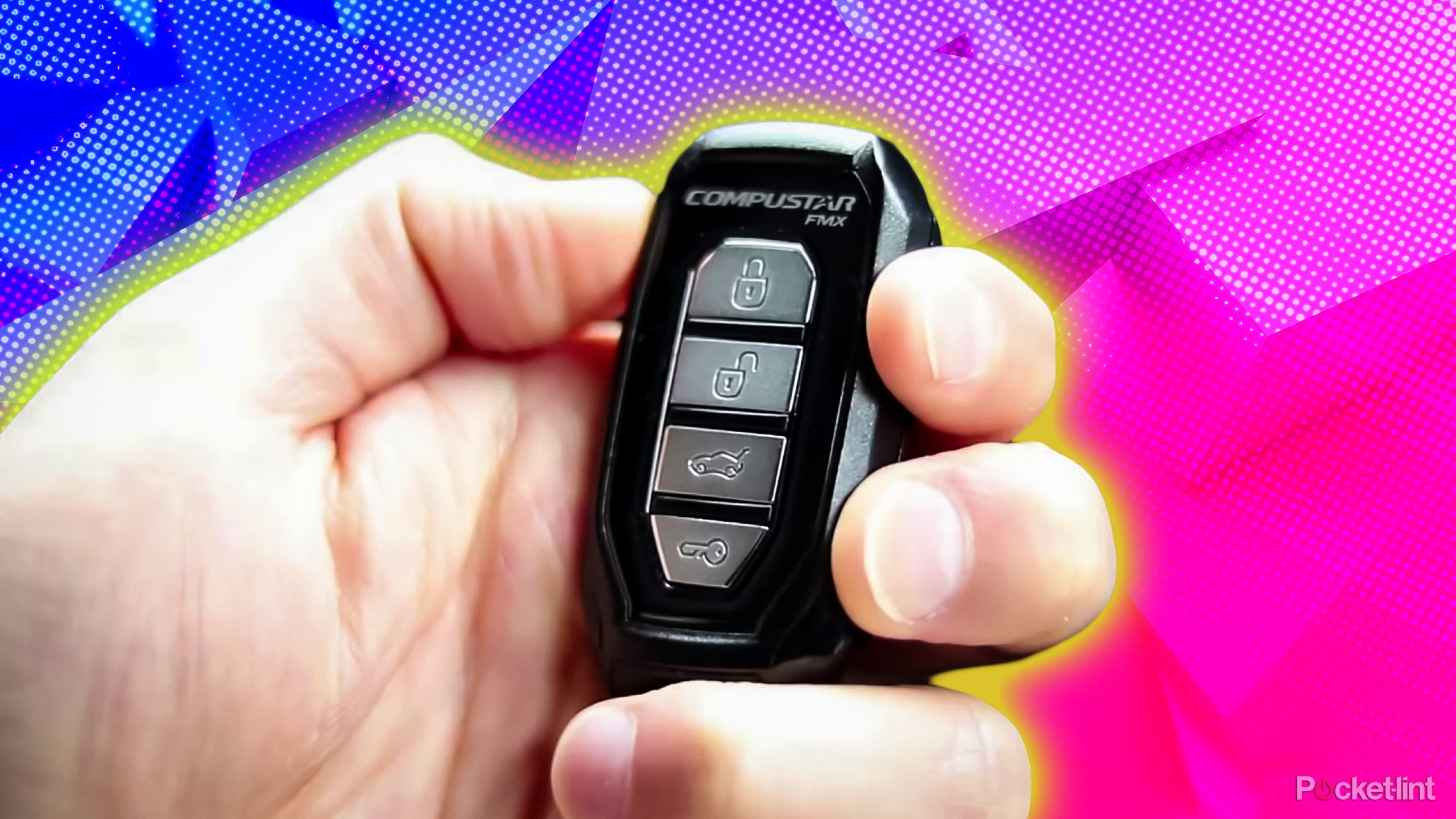 A hand holding a key fob. 