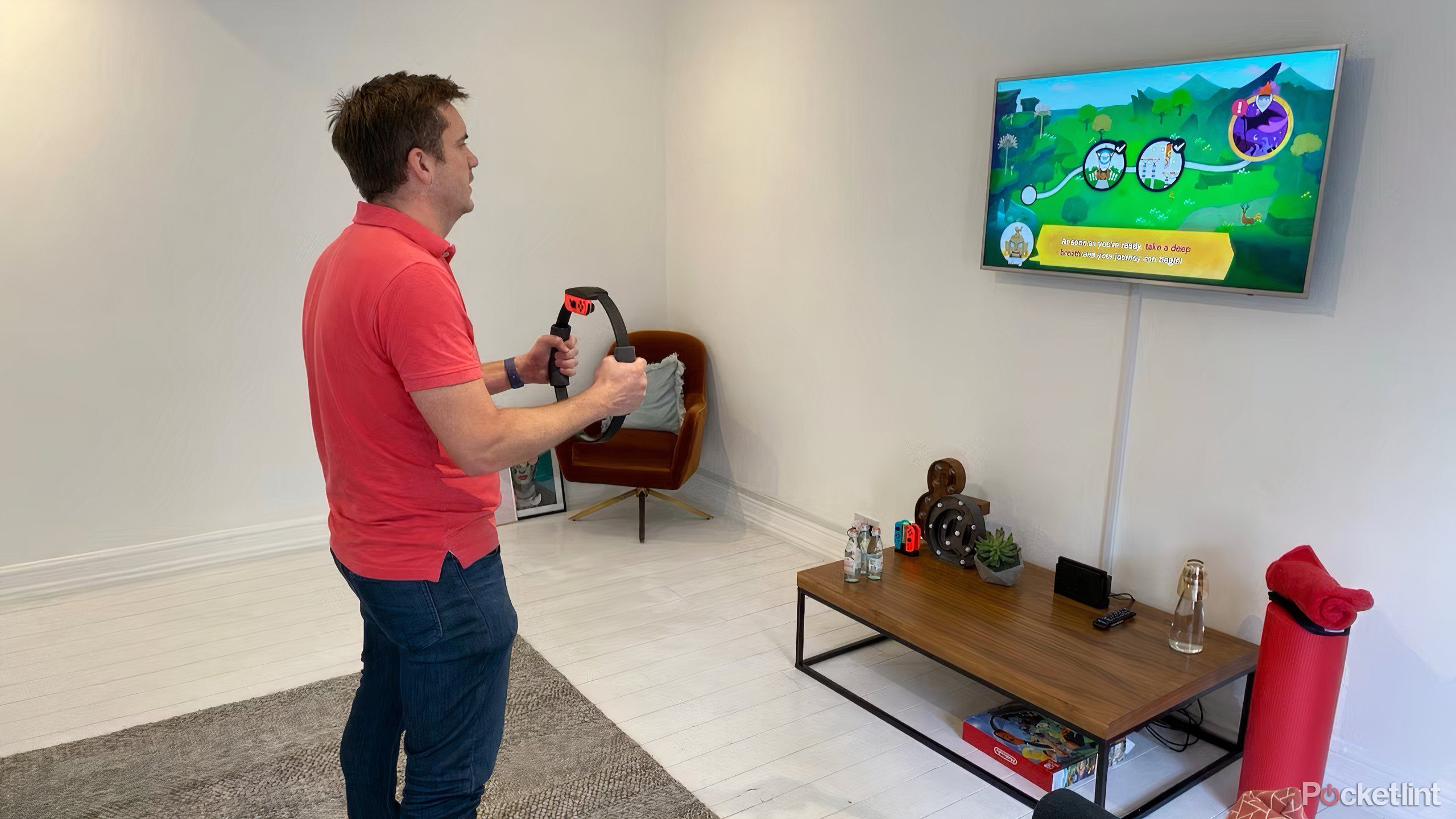 Someone standing in front of a TV playing Ring Fit Adventure with the Switch's ring accessory.