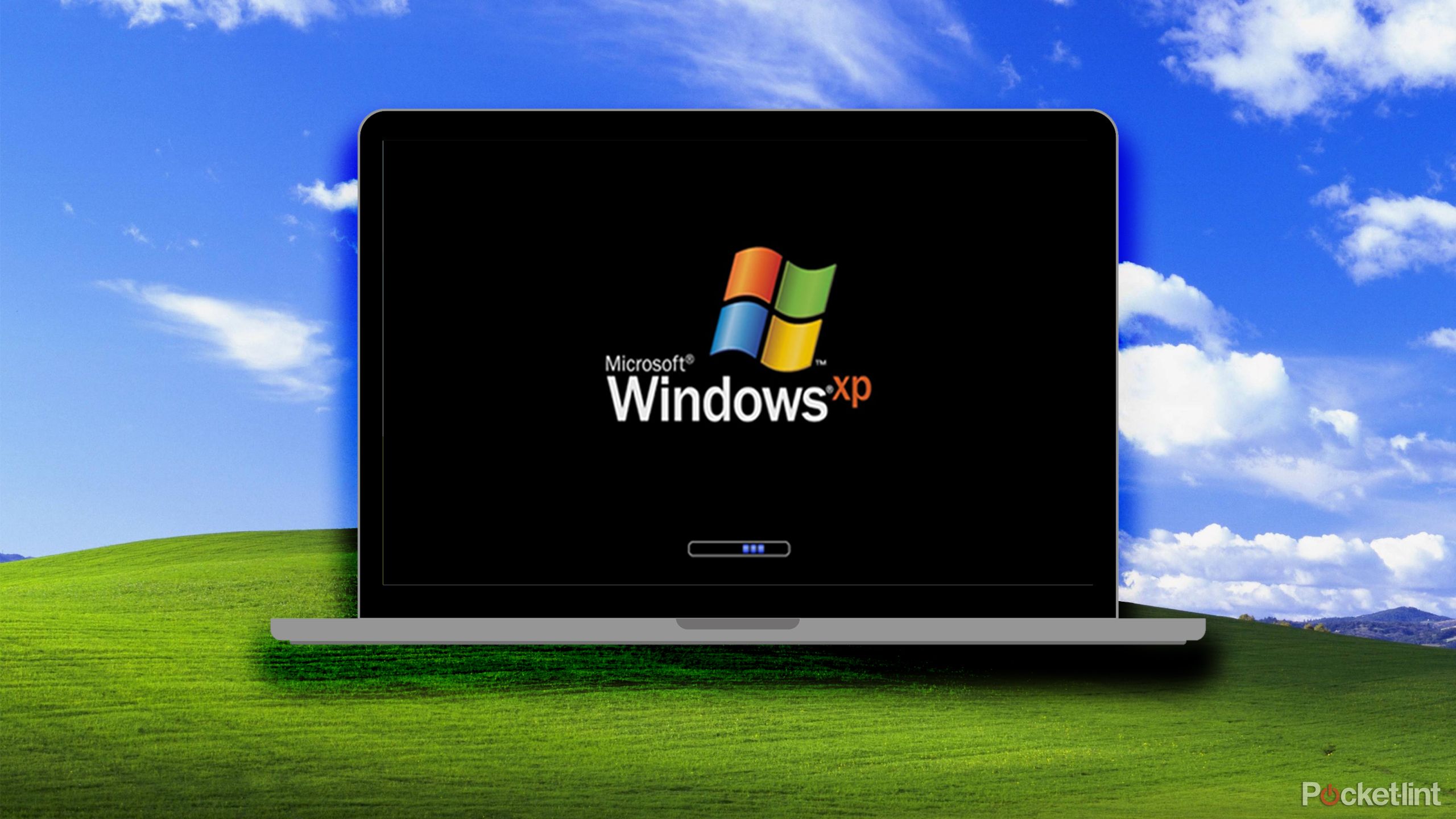 Windows XP on laptop on Windows XP green hill background.