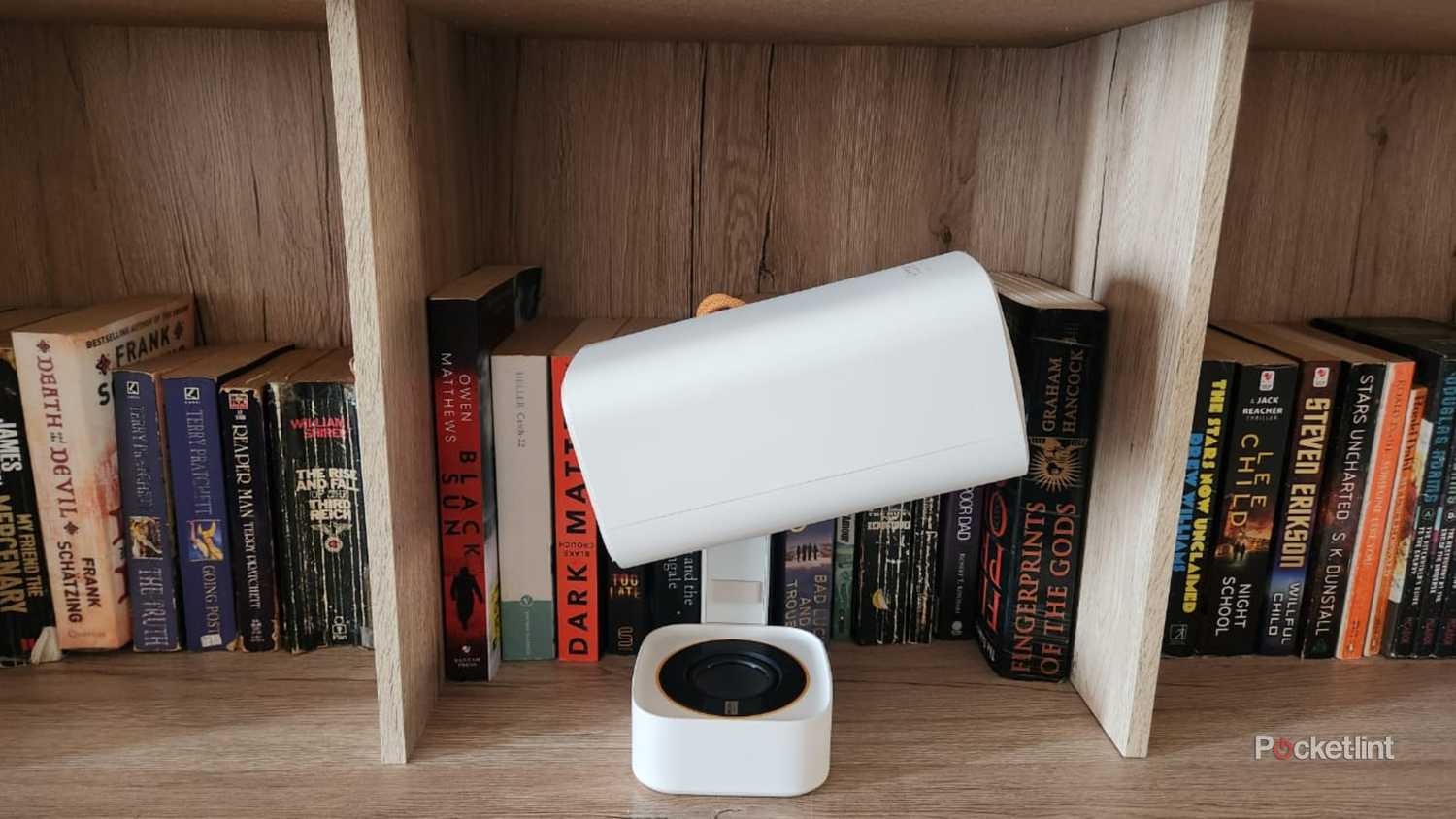 Yaber T1 projector on a book case