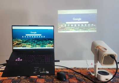 A laptop and projector on a table.