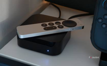 Apple TV 4K sitting on a TV shelf