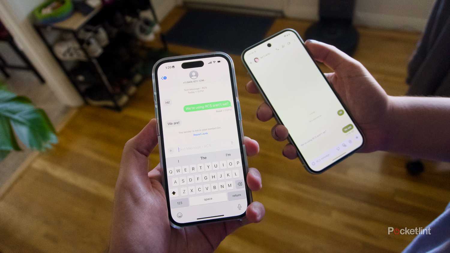 A hand holding an iPhone texting a Pixel.