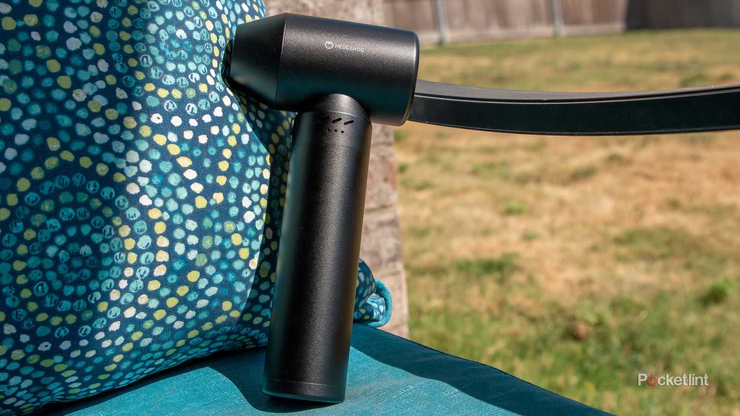 A still photo of the Hedgehog JET propped up against the arm of an outdoor chair. 