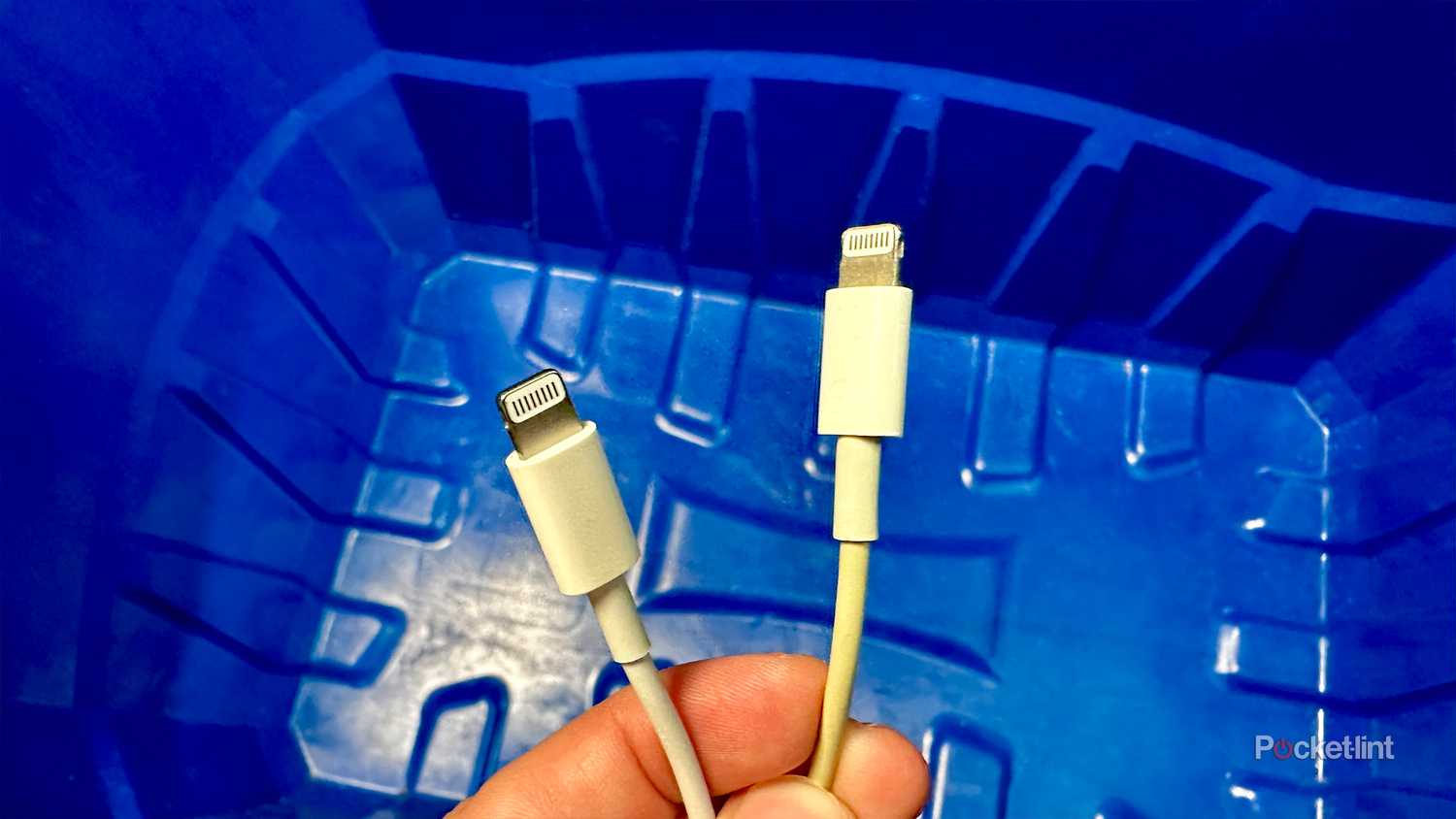 Lightning cable near recycle bin.