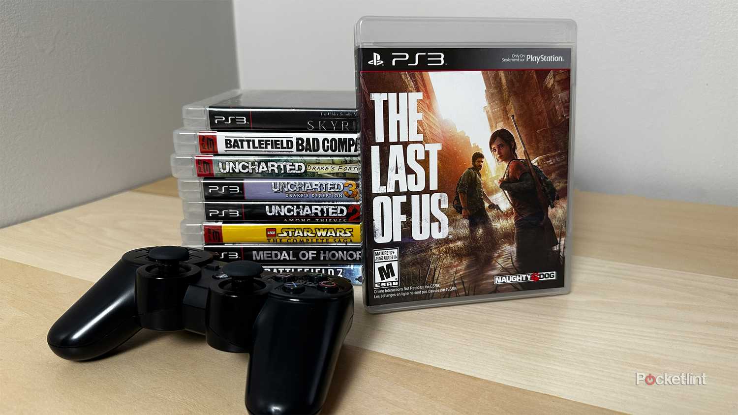 PS3 games next to PS3 controller.